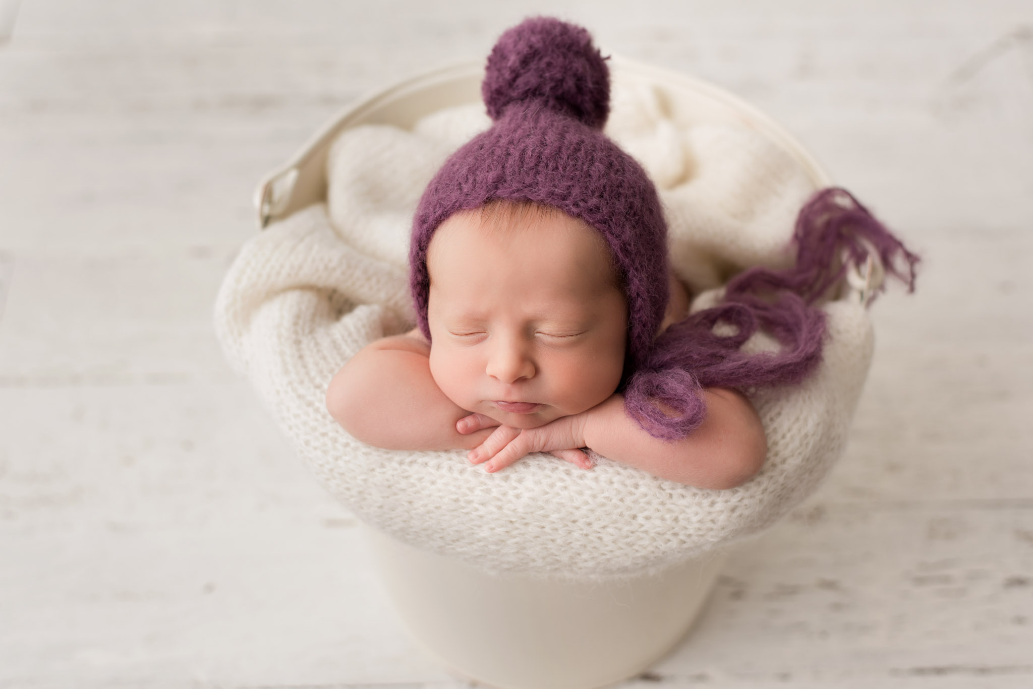 phoenix newborn baby in bucket with knit hat